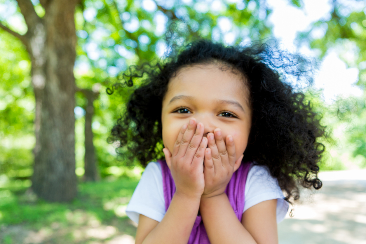 Child laughing outdoors