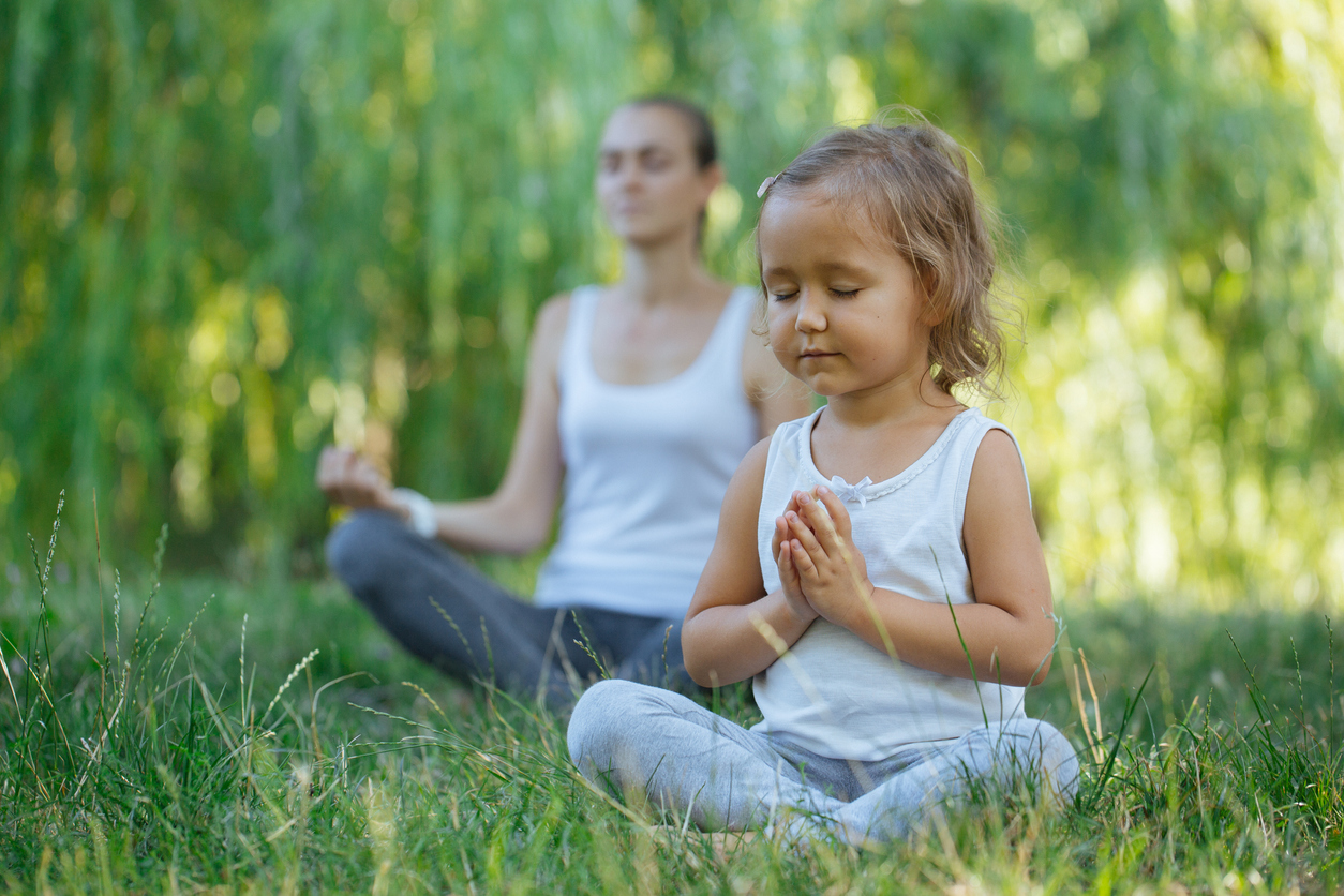 Child meditating with parent